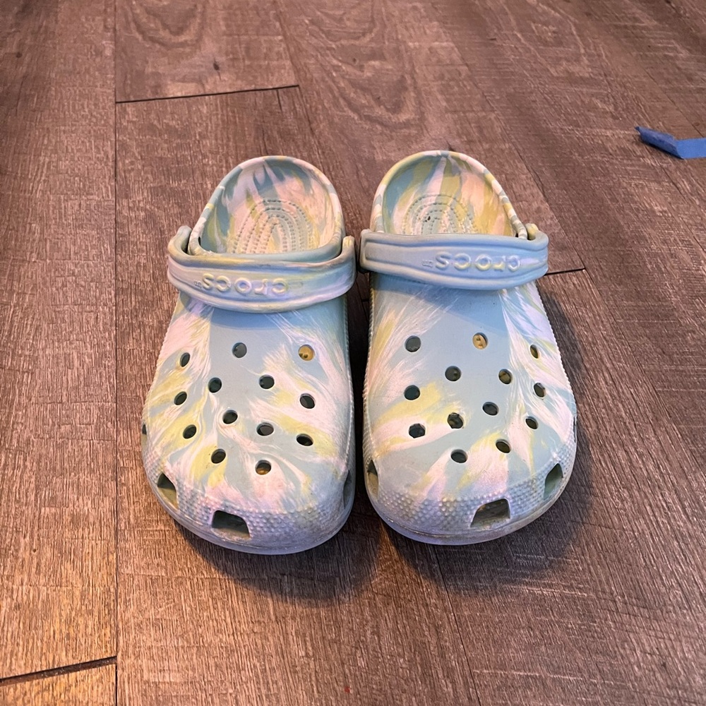 Blue green and white crocs